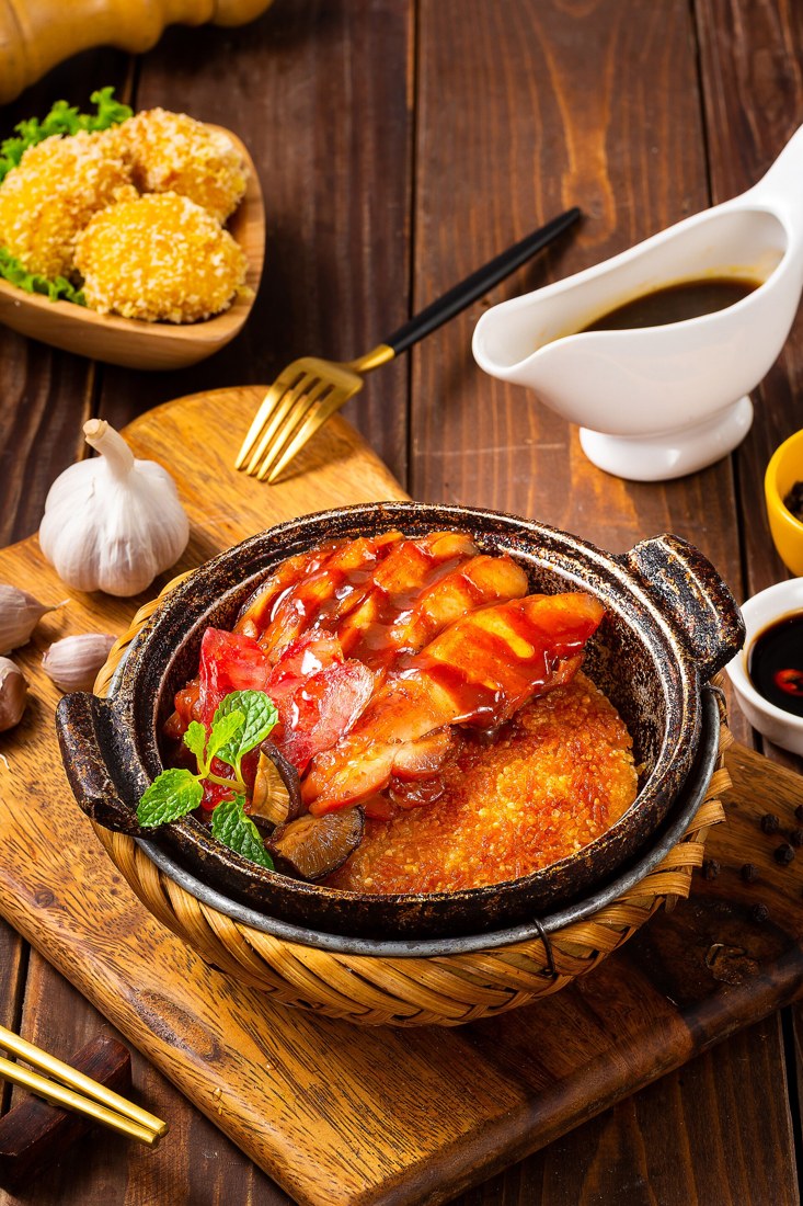 Niêu cơm ăn cùng thịt sốt và rau trong ảnh minh họa món ăn