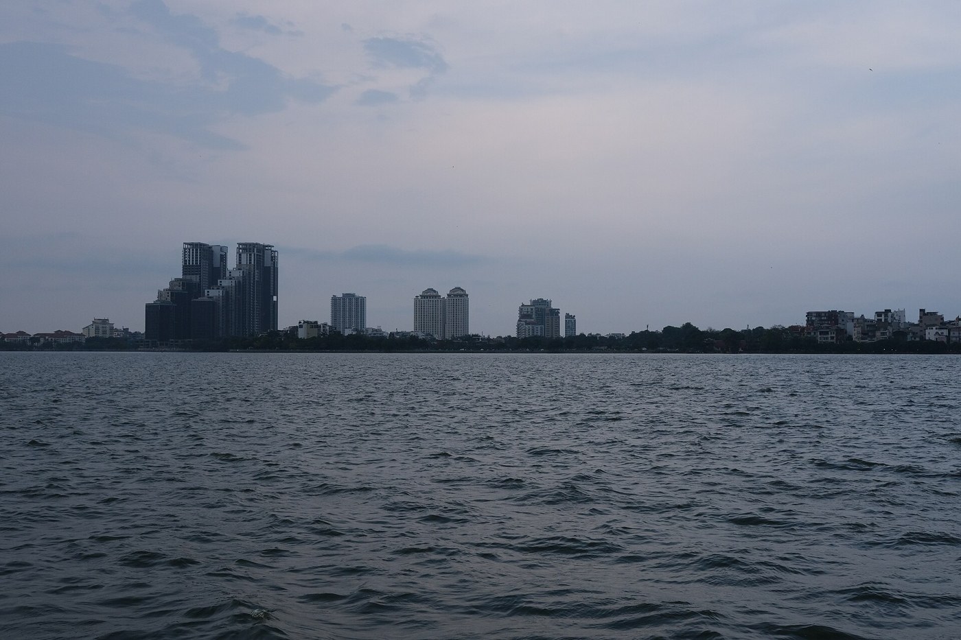 West Lake skyline in Hanoi under February clouds